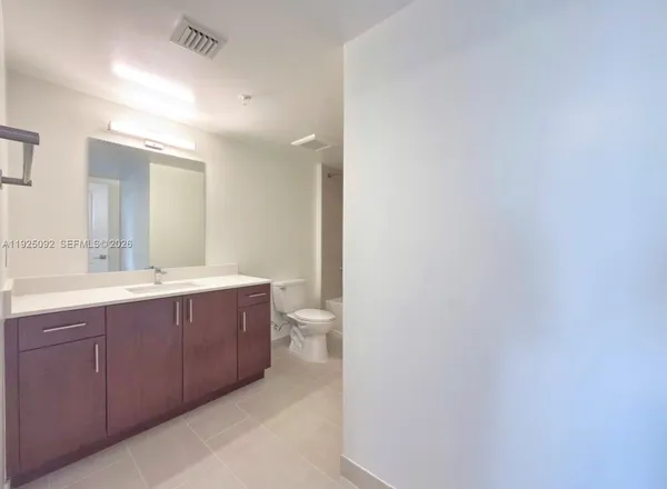 a bathroom with a bathtub sink vanity and mirror