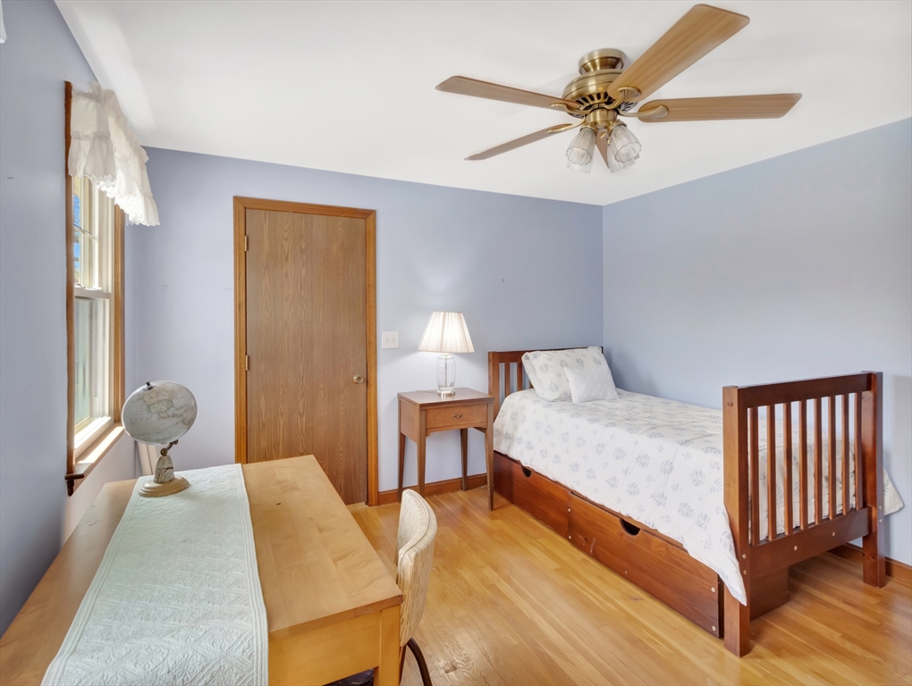 15 Riverside Drive Mansfield, MA 02048 - Photo 26 of 42 a bed room with a bed and a chandelier