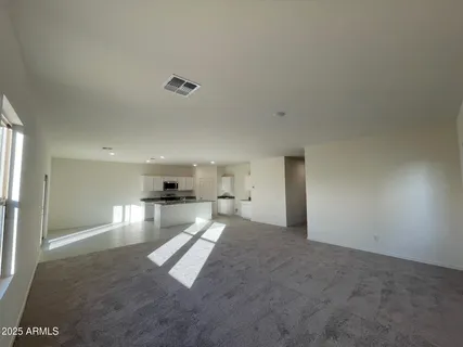 a view of a kitchen with a sink and a refrigerator