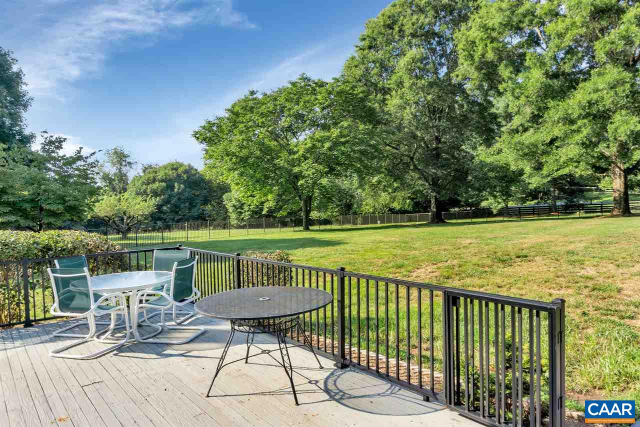 255 Rivanwood Place Charlottesville, VA 22901 - Photo 14 of 25 a view of a lake with a table and chairs next to a yard