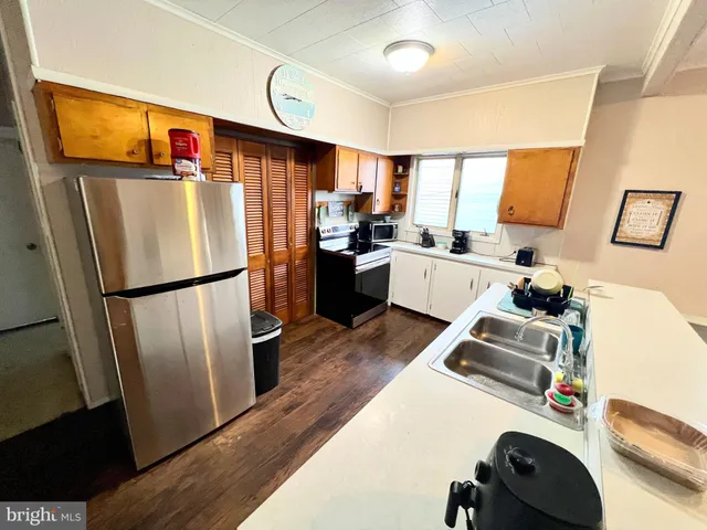 a kitchen with a refrigerator a stove and a sink