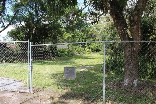 a backyard of a house with lots of trees