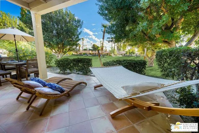 a view of a patio with chairs and a table
