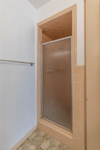 a bathroom with a glass shower door