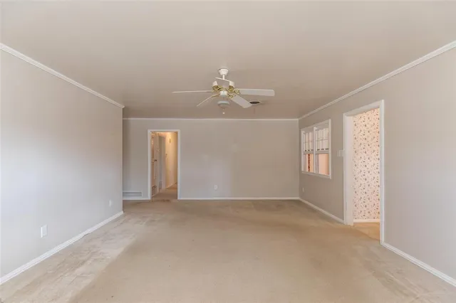 a view of a room with window and ceiling fan