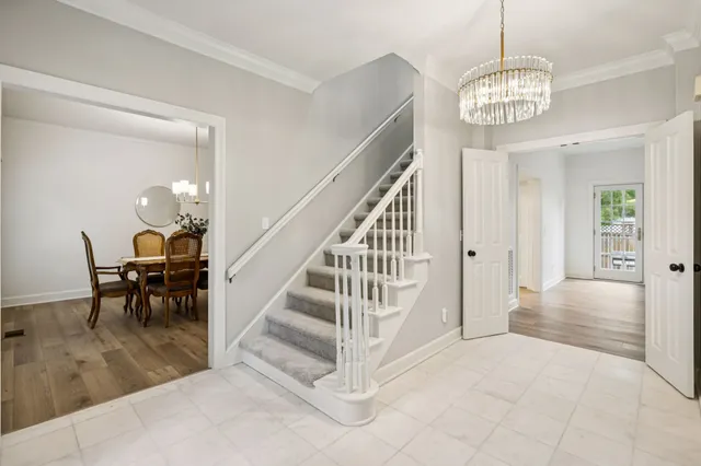 a bedroom with bed and a chandelier