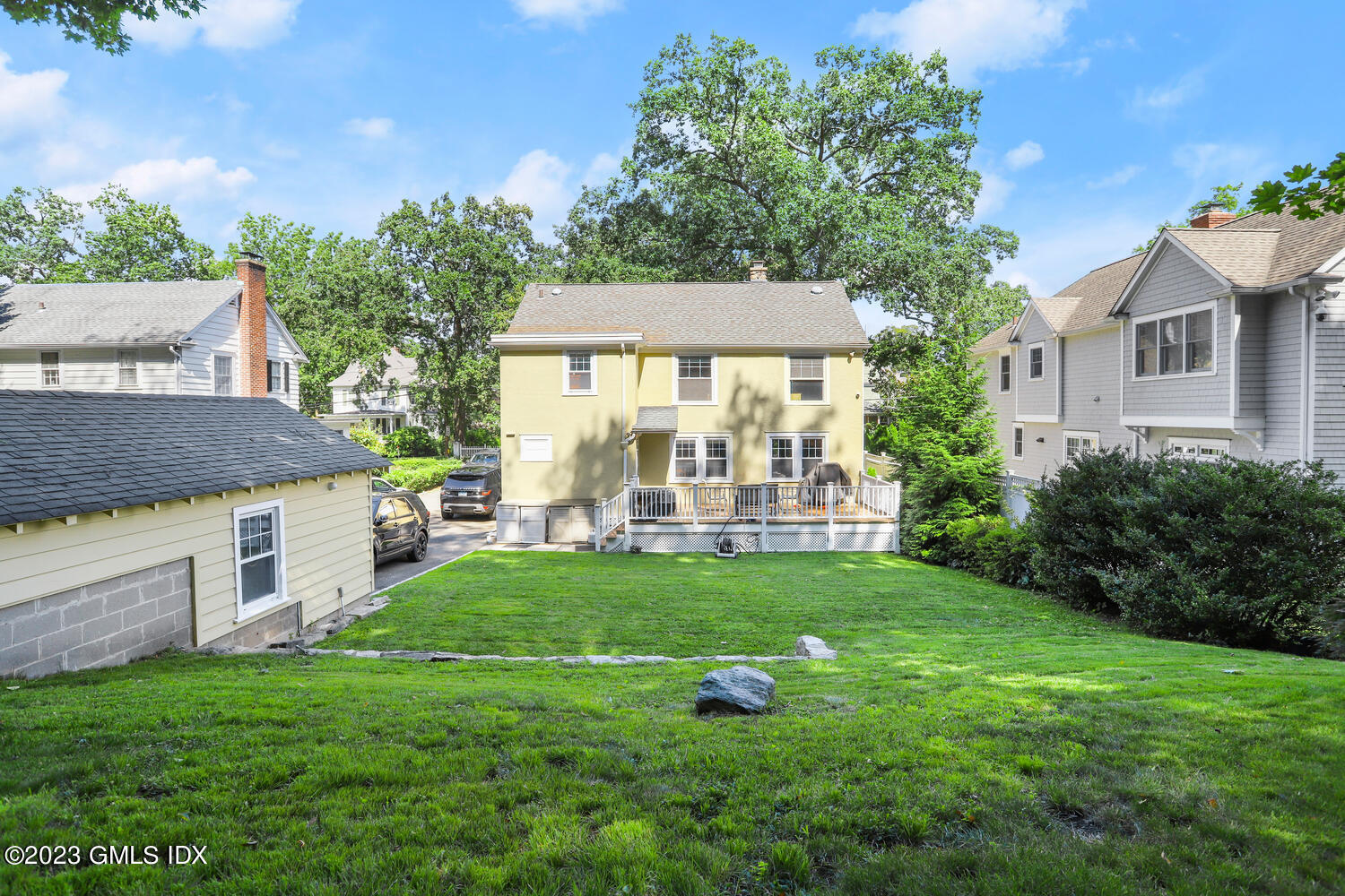 30 Sinawoy Road Cos Cob, CT 06807 - Photo 18 of 21 a backyard of a house with table and chairs plants and large tree
