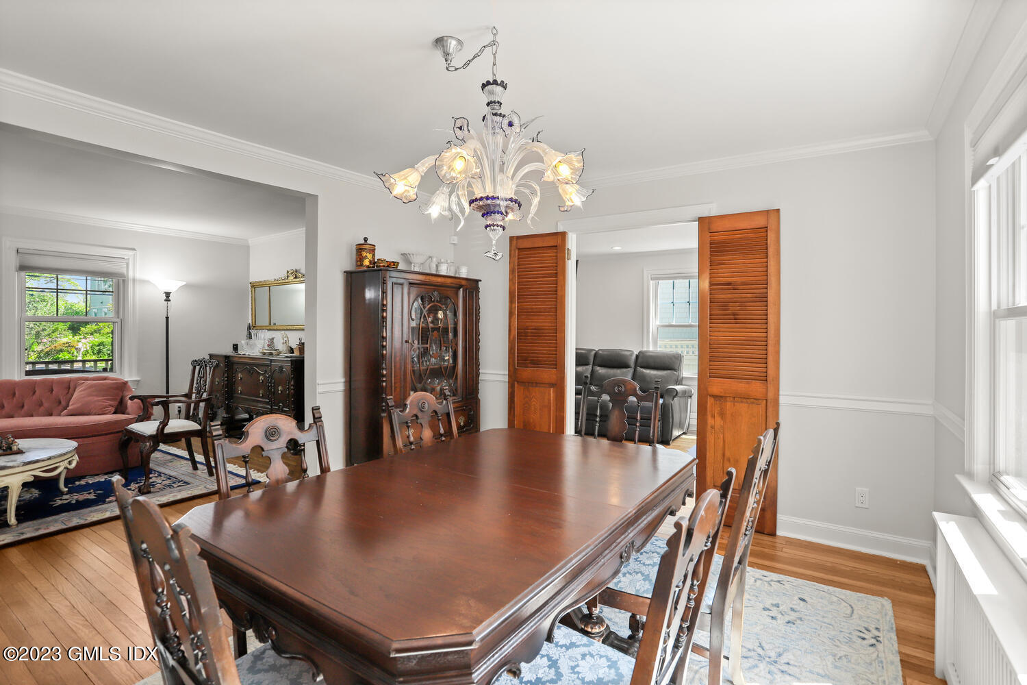 30 Sinawoy Road Cos Cob, CT 06807 - Photo 5 of 21 a dining room with furniture a chandelier and wooden floor