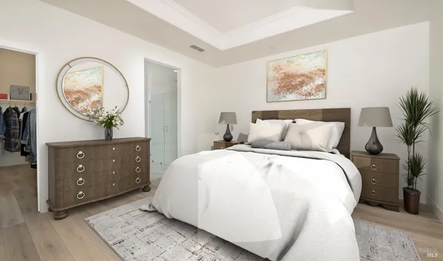 a bedroom with a bed and paintings on the wall