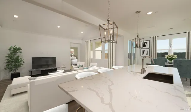 a large bedroom with a large bed and a flat tv screen