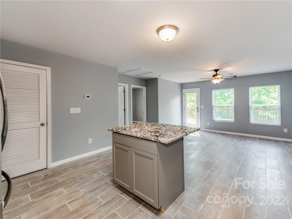 1032 Unity Pointe Lane Kings Mountain, NC 28086 - Photo 15 of 29 a kitchen with stainless steel appliances granite countertop a stove and a wooden floors