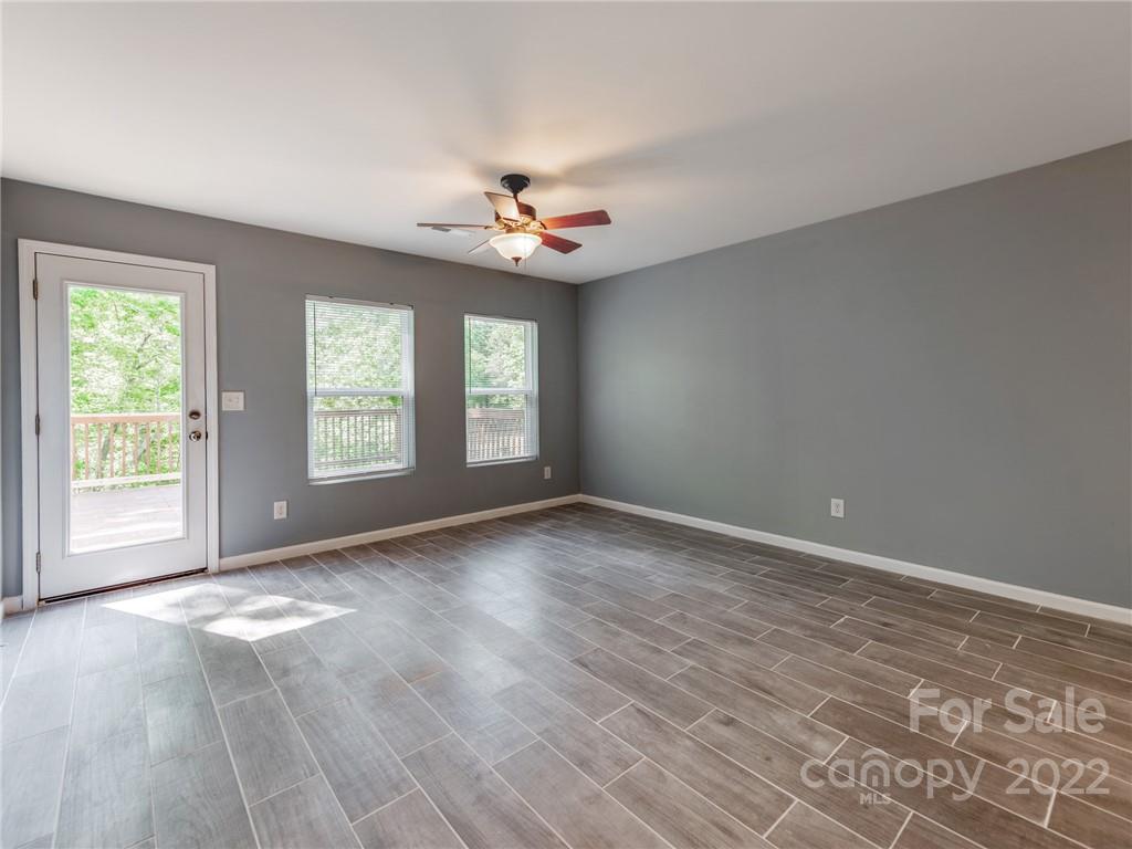 1032 Unity Pointe Lane Kings Mountain, NC 28086 - Photo 16 of 29 an empty room with windows and ceiling fan