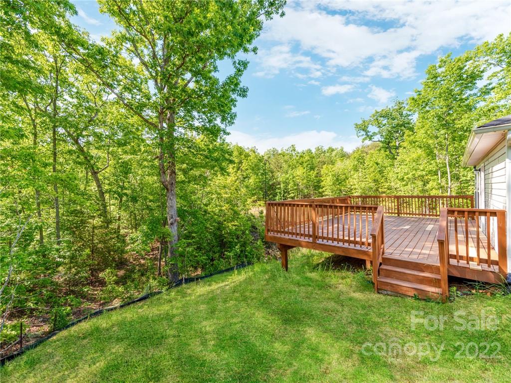 1032 Unity Pointe Lane Kings Mountain, NC 28086 - Photo 24 of 29 a view of a wooden deck with a bench and a yard
