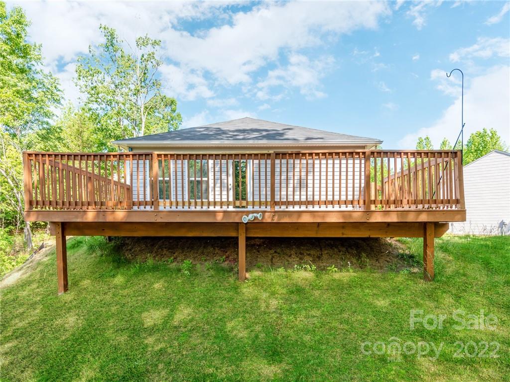 1032 Unity Pointe Lane Kings Mountain, NC 28086 - Photo 28 of 29 a backyard of a house with wooden deck and outdoor seating
