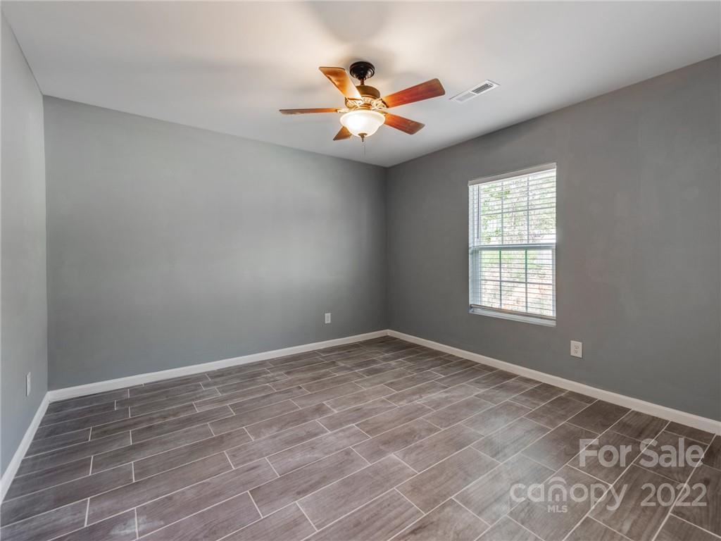 1032 Unity Pointe Lane Kings Mountain, NC 28086 - Photo 6 of 29 wooden floor in an empty room with a window