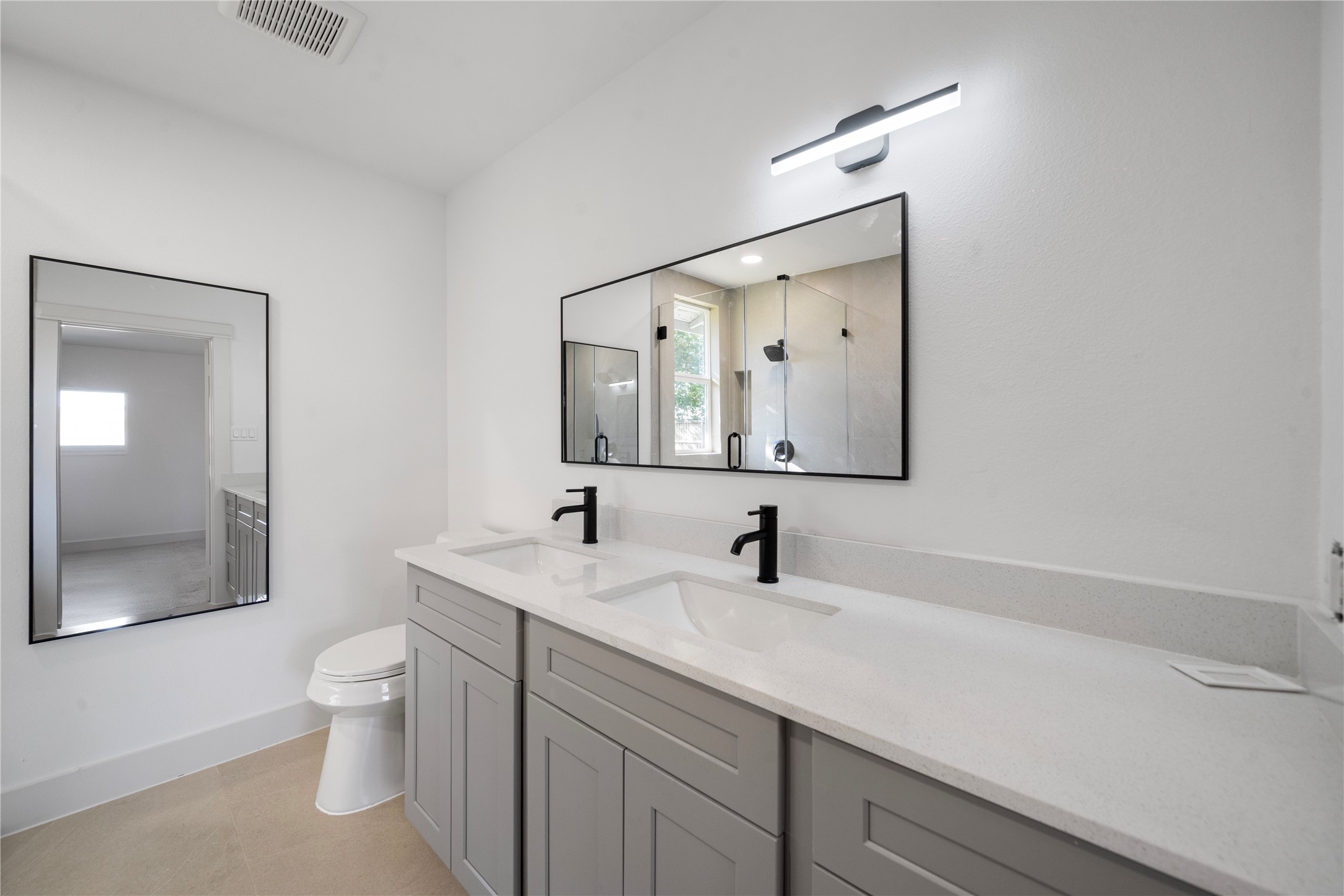 5114 Keystone Street Houston, TX 77021 - Photo 18 of 29 a bathroom with a toilet a sink a mirror and vanity
