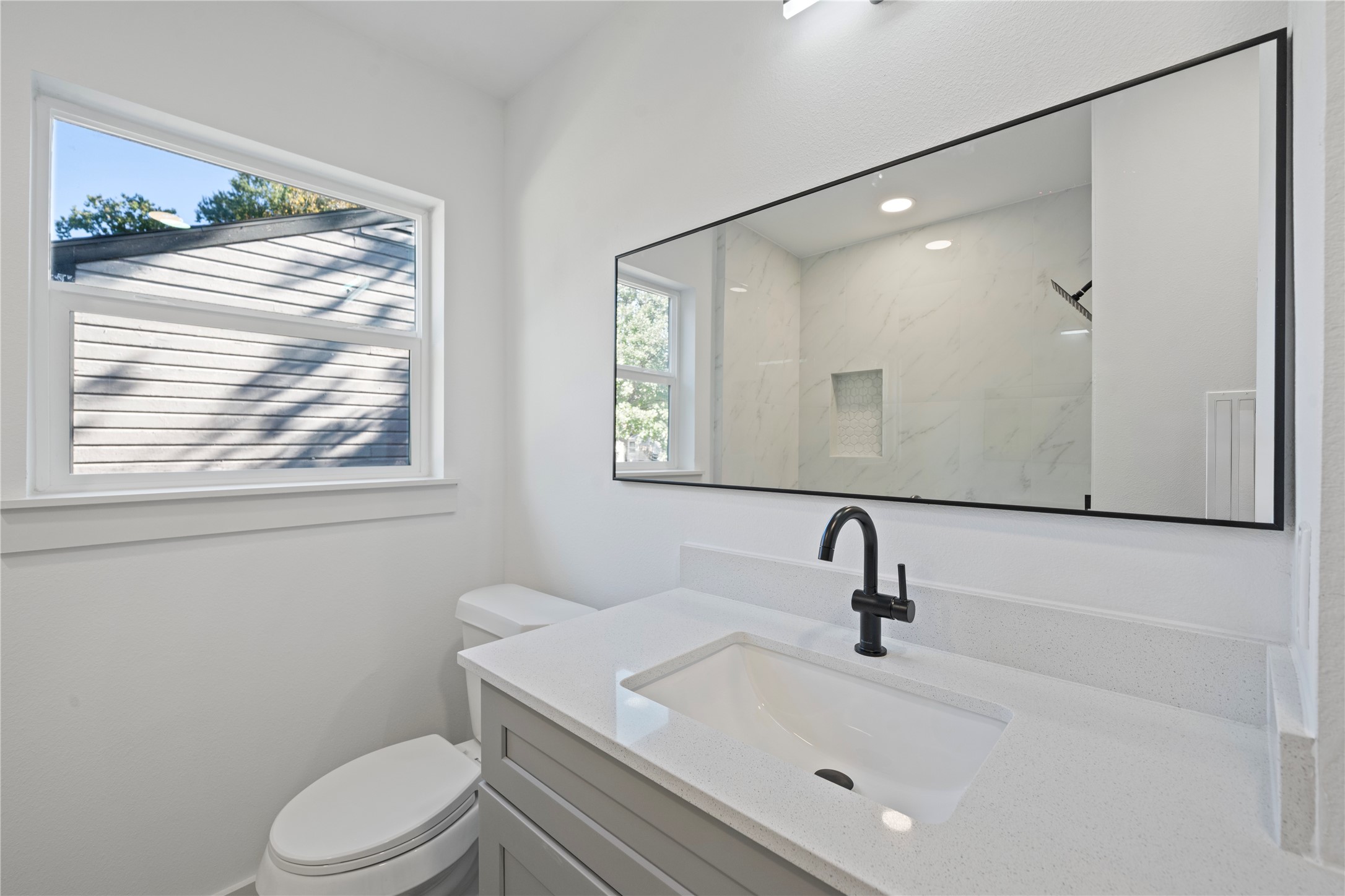 5114 Keystone Street Houston, TX 77021 - Photo 22 of 29 a bathroom with a sink a mirror and a toilet