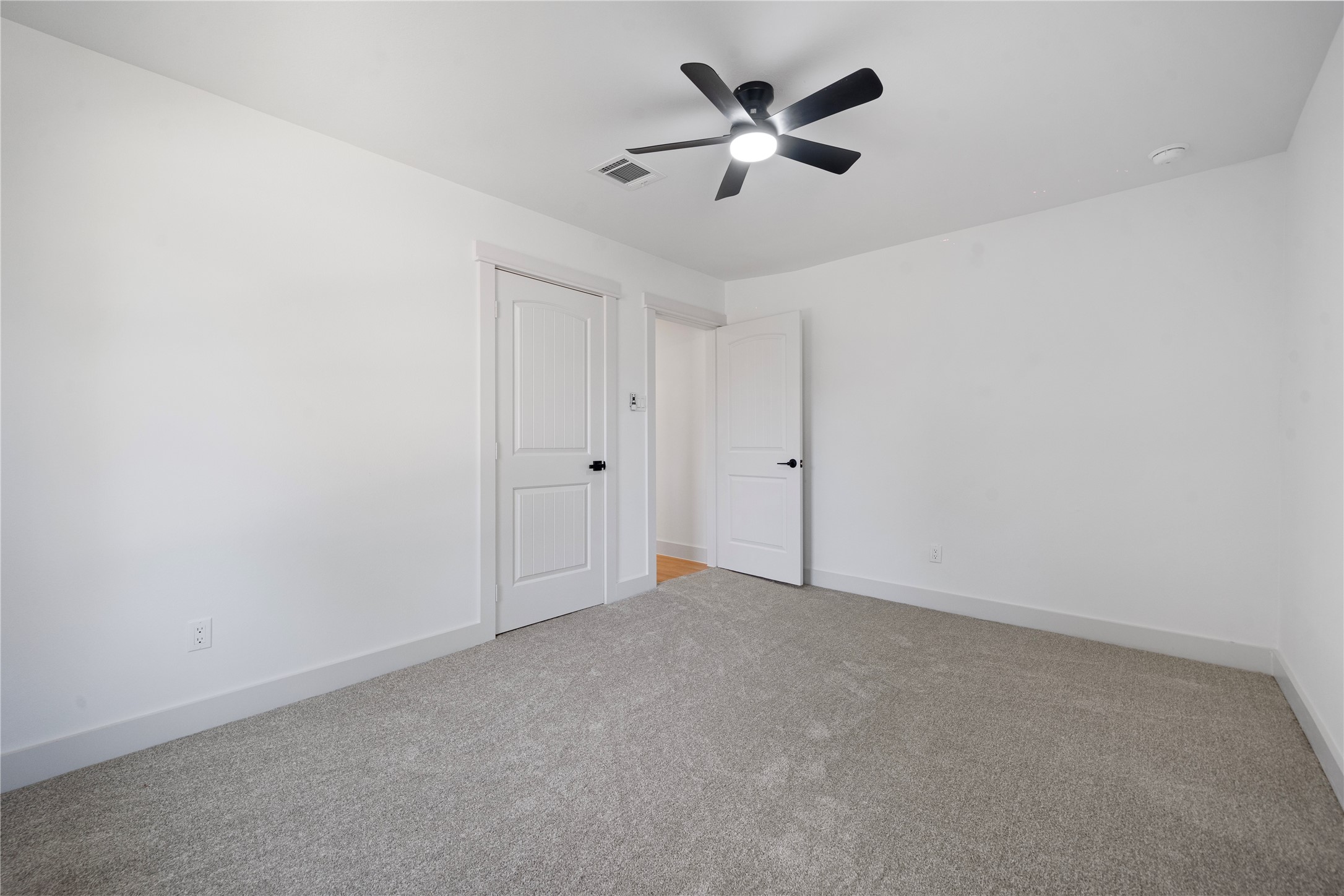 5114 Keystone Street Houston, TX 77021 - Photo 24 of 29 an empty room with a hallway and a ceiling fan