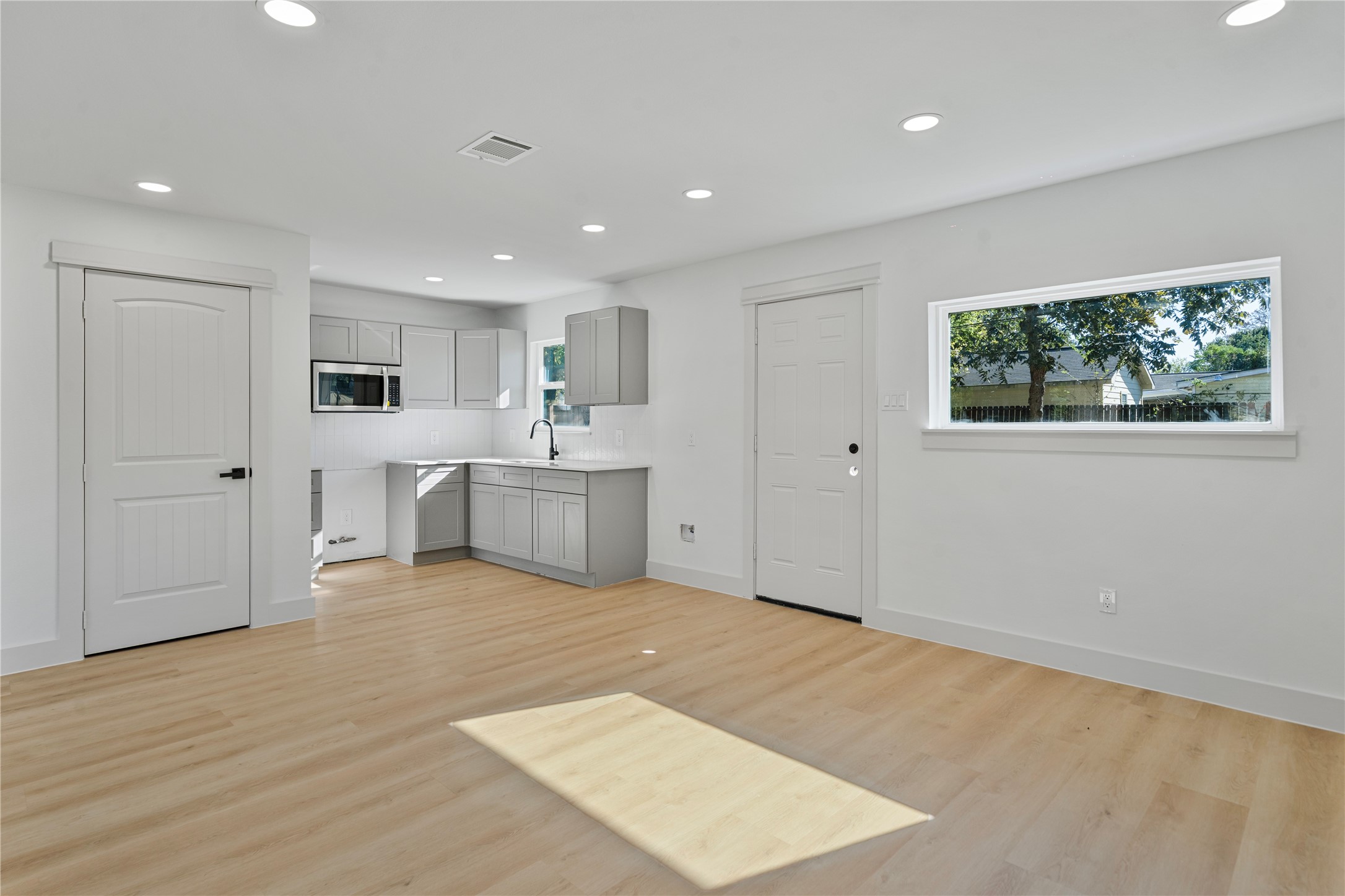 5114 Keystone Street Houston, TX 77021 - Photo 3 of 29 a view of an empty room with window and wooden floor