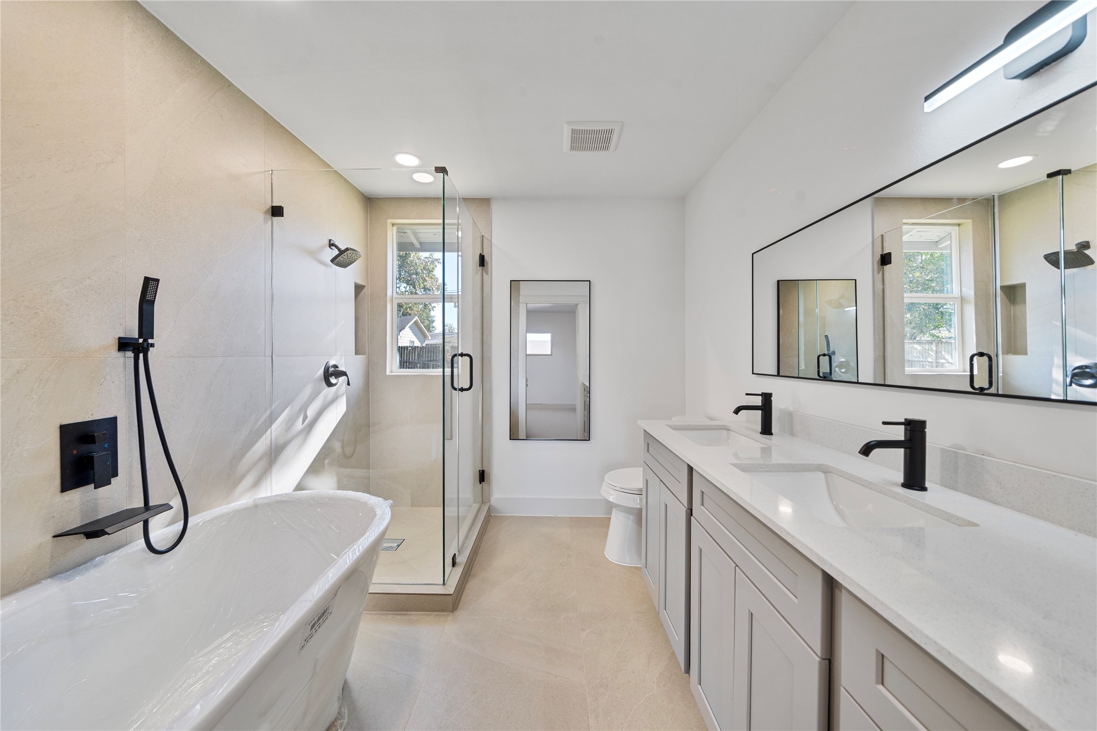 5114 Keystone Street Houston, TX 77021 - Photo 9 of 29 a bathroom with a sink a toilet a mirror and shower