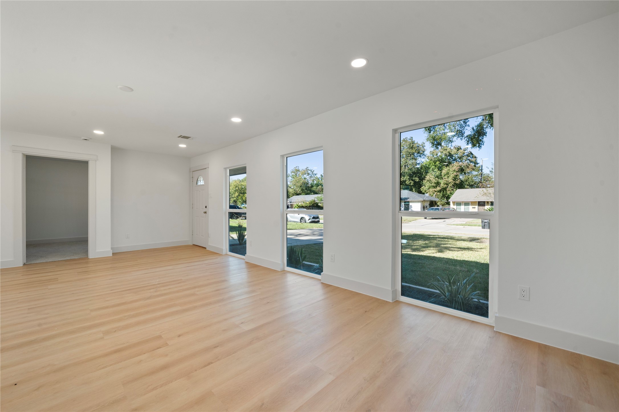 5114 Keystone Street Houston, TX 77021 - Photo 10 of 29 a view of an empty room with window and wooden floor