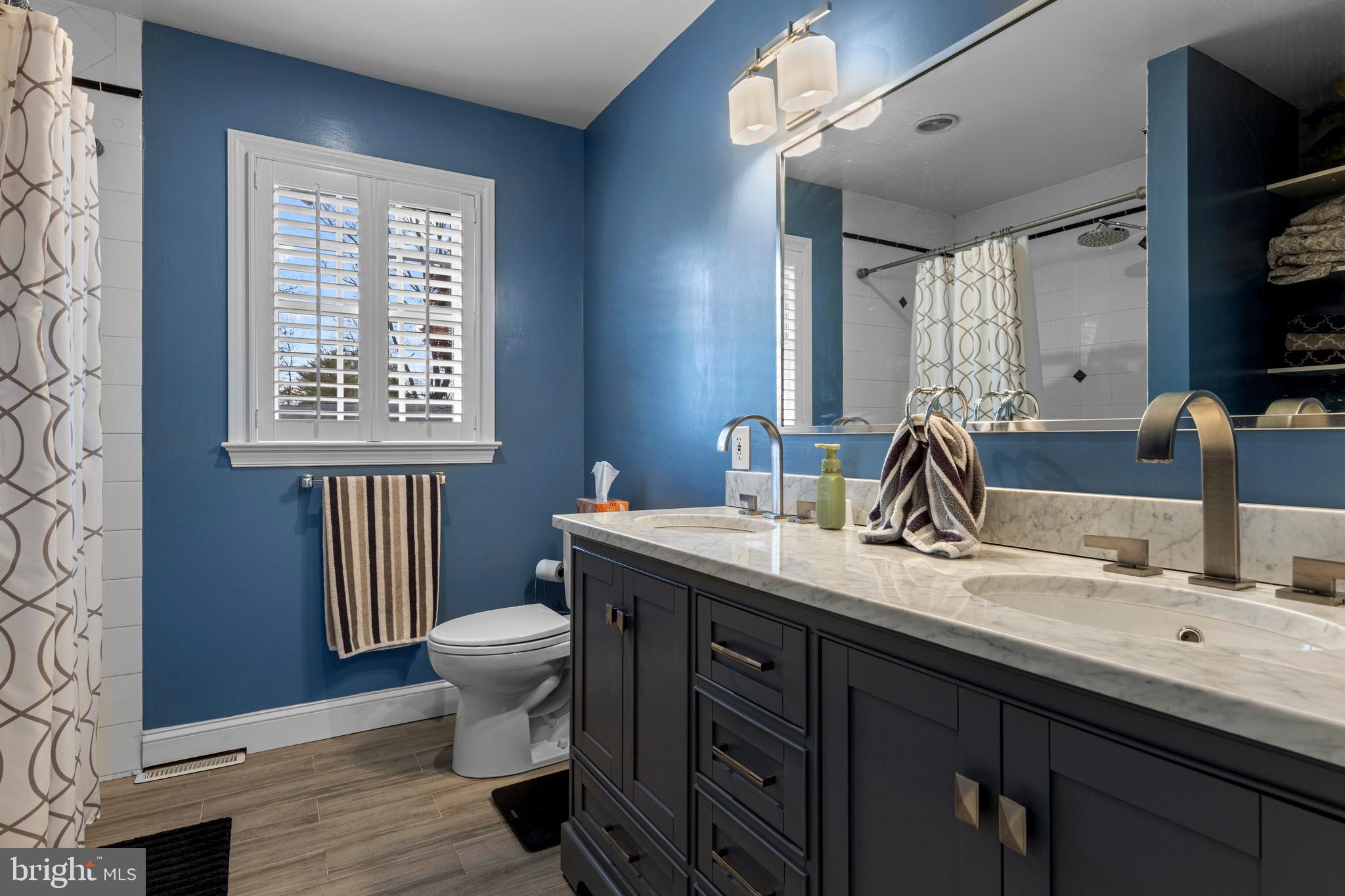 1586 Salomon Lane Chesterbrook, PA 19087 - Photo 40 of 47 a bathroom with a toilet sink and mirror