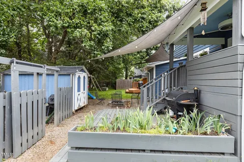 a view of a house with furniture and a fire pit