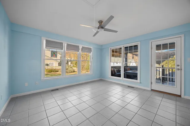 a view of empty room with fireplace and fan