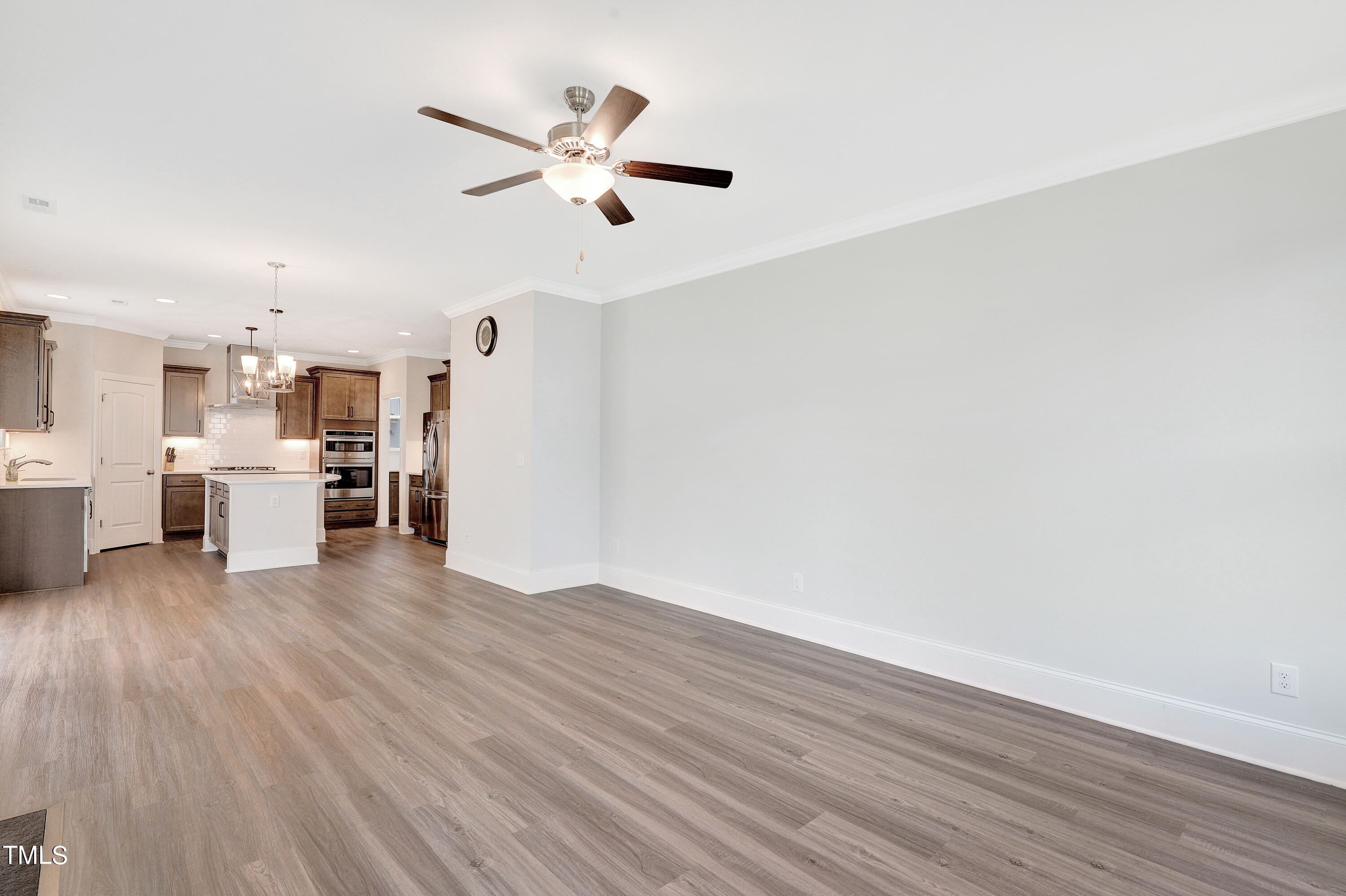 2153 Sweet Samson Street Wake Forest, NC 27587 - Photo 15 of 47 a view of a kitchen with wooden floor and a ceiling fan