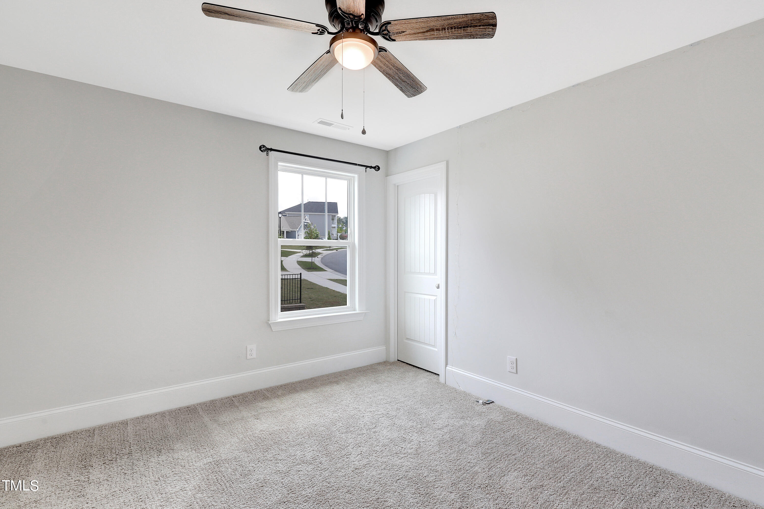 2153 Sweet Samson Street Wake Forest, NC 27587 - Photo 32 of 47 an empty room with a window and a fan