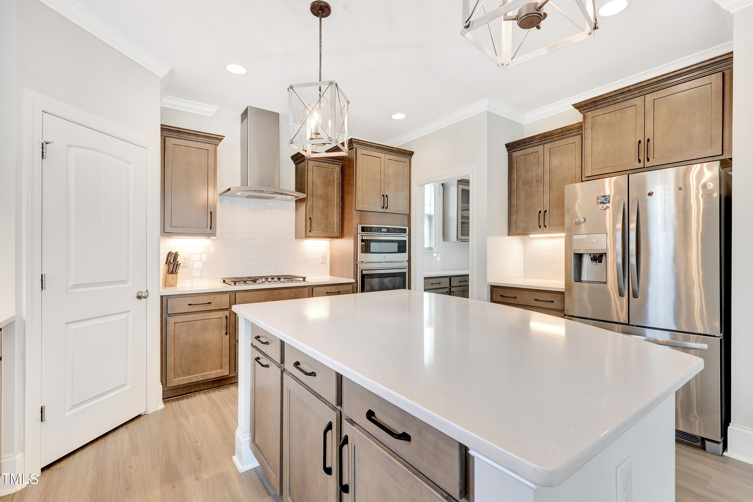 2153 Sweet Samson Street Wake Forest, NC 27587 - Photo 7 of 47 a kitchen with stainless steel appliances a refrigerator sink and stove