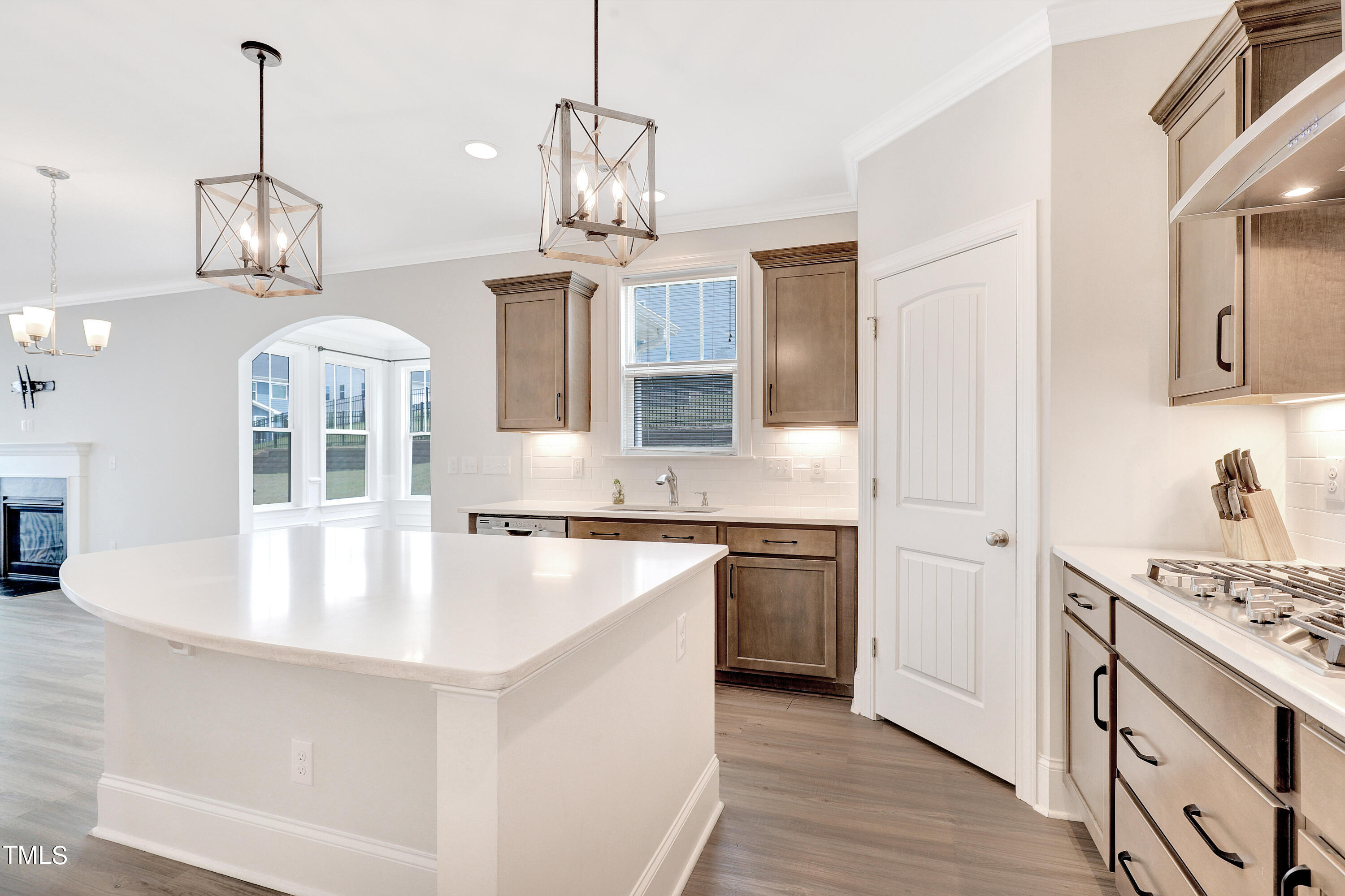 2153 Sweet Samson Street Wake Forest, NC 27587 - Photo 8 of 47 a large kitchen with kitchen island granite countertop a stove a sink a center island and wooden floor