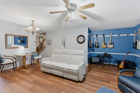 a living room with furniture and wooden floor