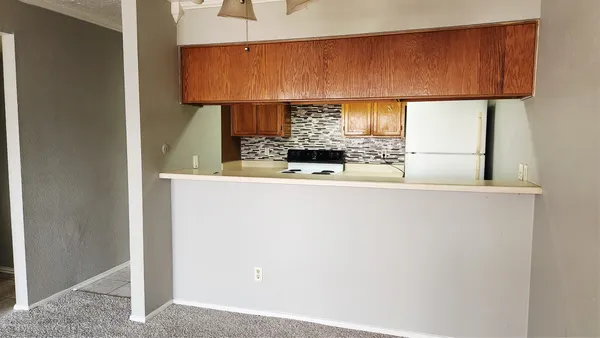 a kitchen with a sink a lamp and a window