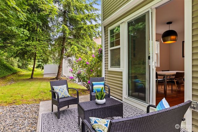 a view of a house with a chairs and table in a patio