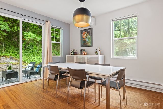 a dining room with furniture window and wooden floor
