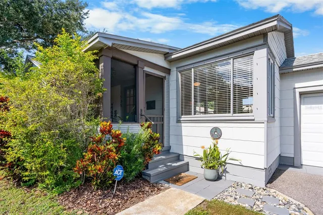 a front view of a house with a chairs
