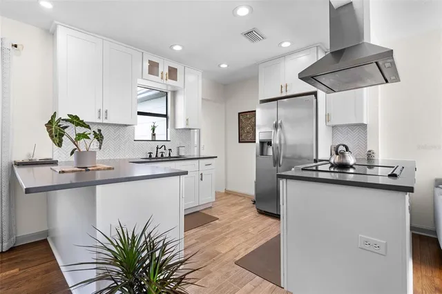 a kitchen with stainless steel appliances a sink stove and refrigerator