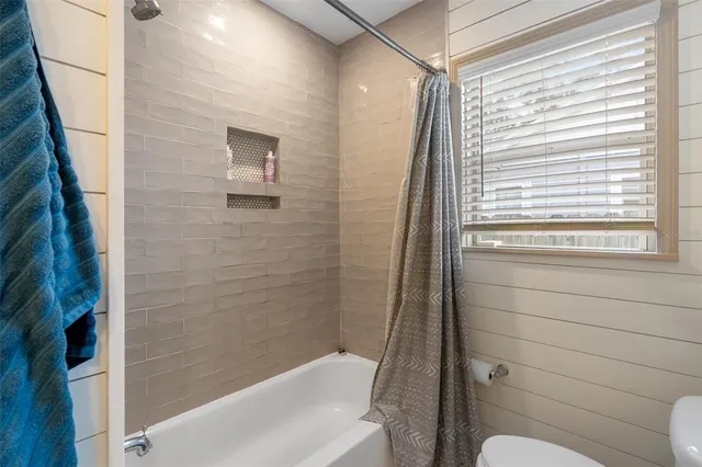 a bathroom with a shower and a toilet