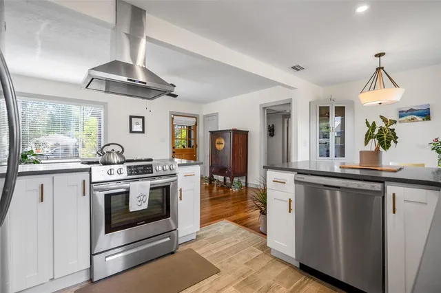 a kitchen with granite countertop a stove and a sink