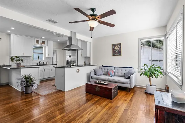a living room with furniture and kitchen view