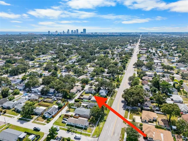 an aerial view of residential houses with city view