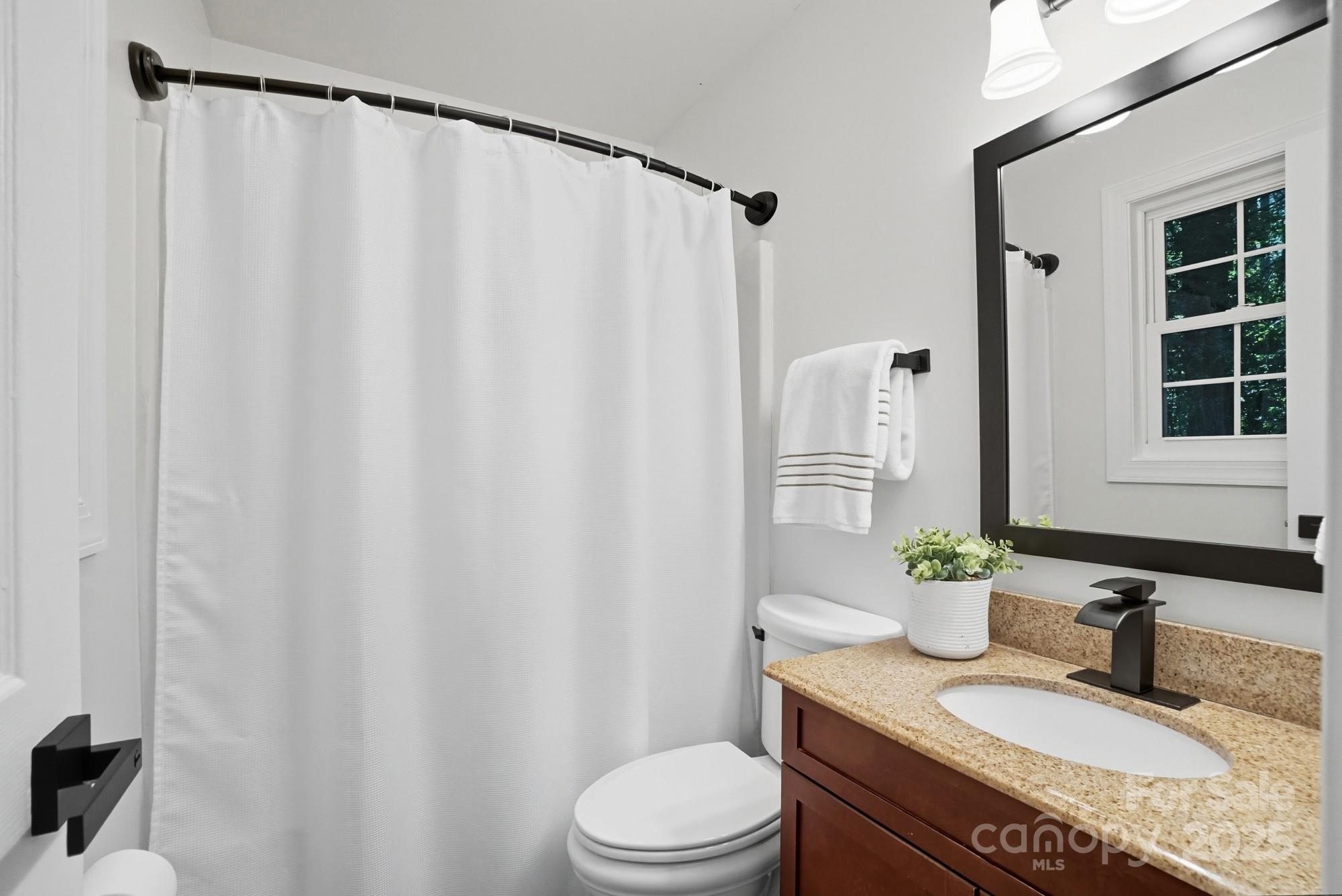 324 West Shiloh Unity Road Lancaster, SC 29720 - Photo 14 of 28 a bathroom with a granite countertop sink and a mirror