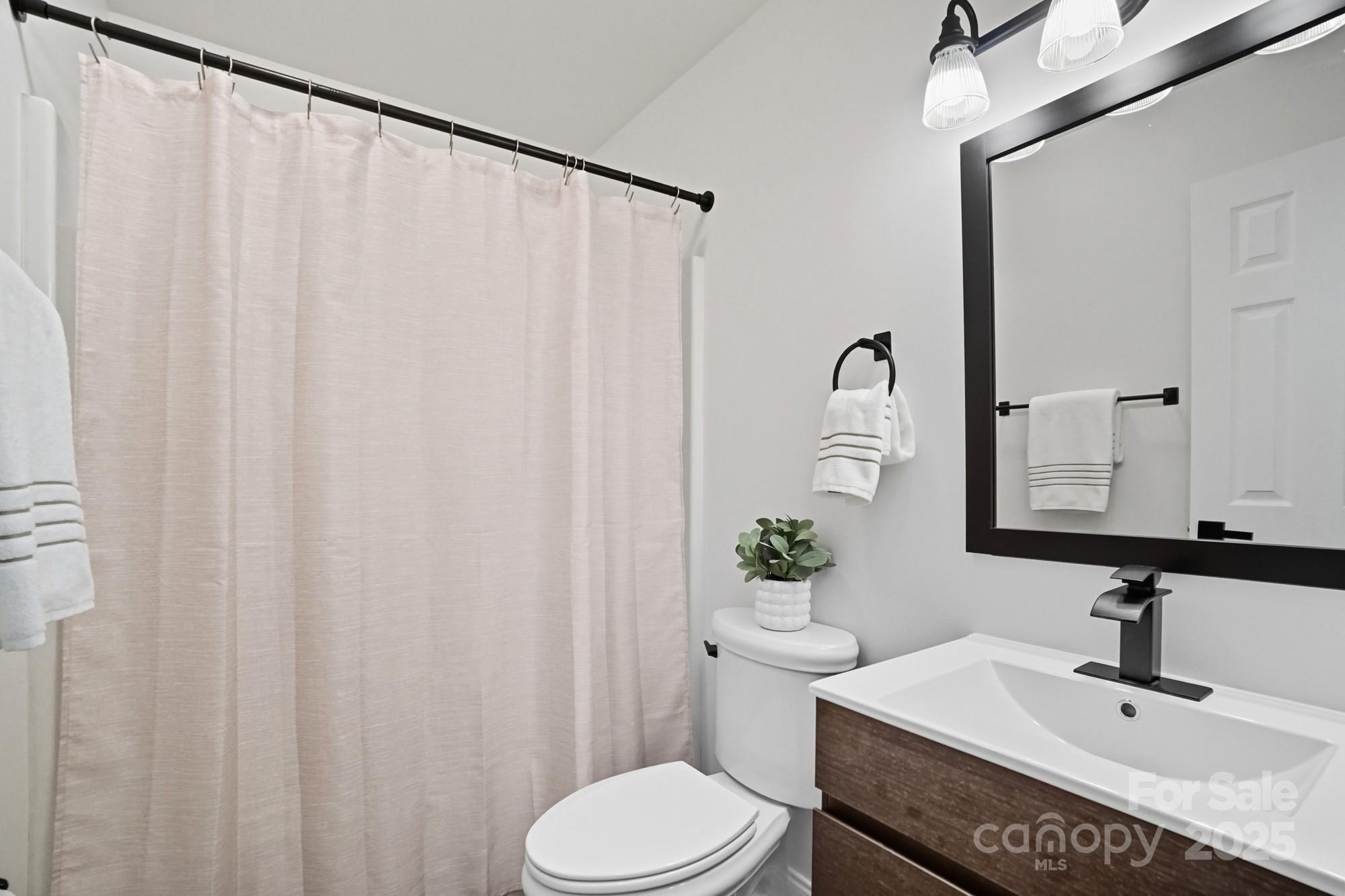 324 West Shiloh Unity Road Lancaster, SC 29720 - Photo 18 of 28 a bathroom with a sink vanity mirror and toilet