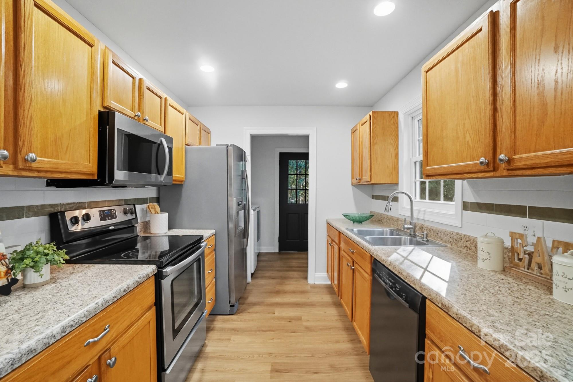 324 West Shiloh Unity Road Lancaster, SC 29720 - Photo 9 of 28 a kitchen with stainless steel appliances granite countertop a stove a sink and a microwave