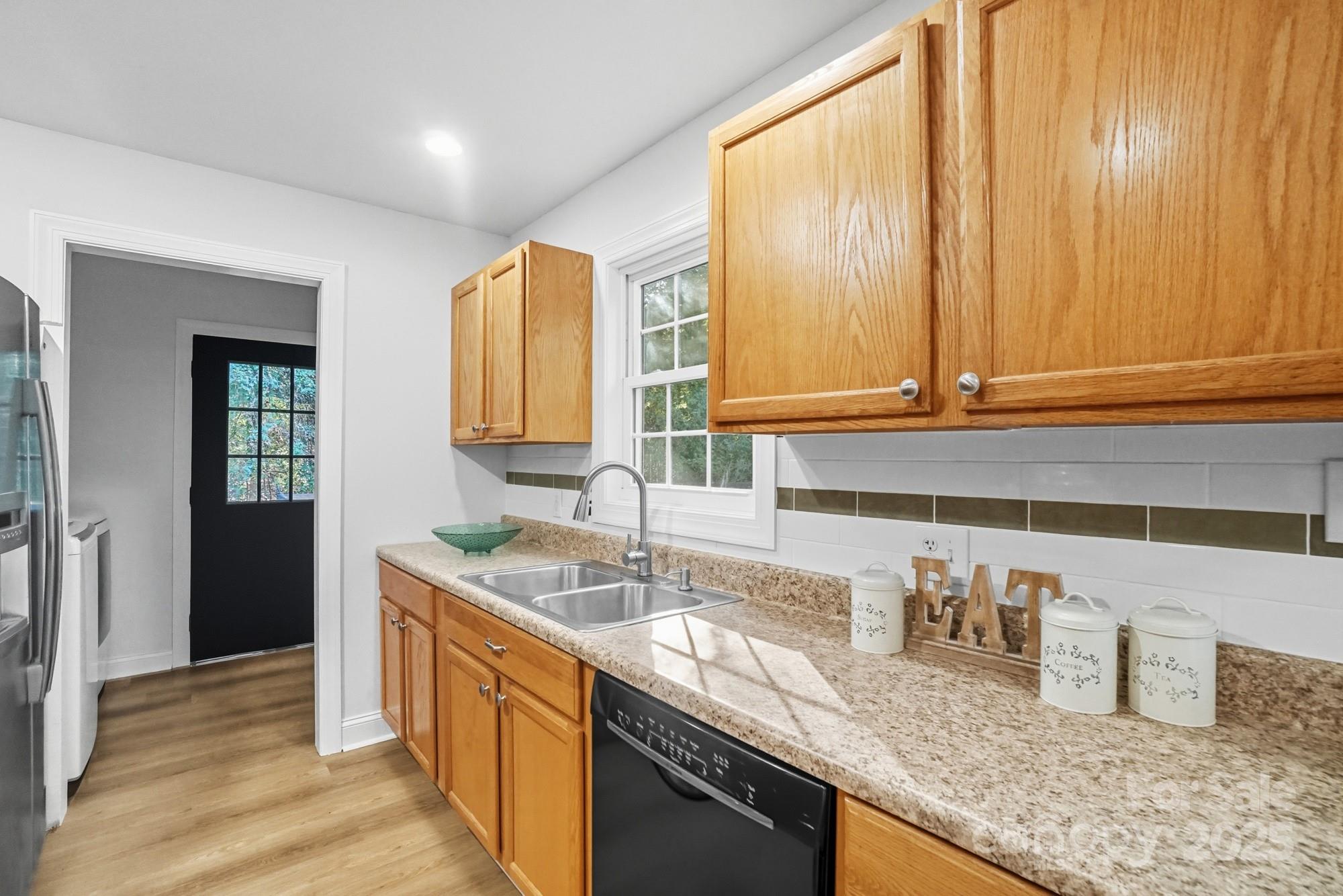 324 West Shiloh Unity Road Lancaster, SC 29720 - Photo 10 of 28 a kitchen with granite countertop a sink a stove and cabinets