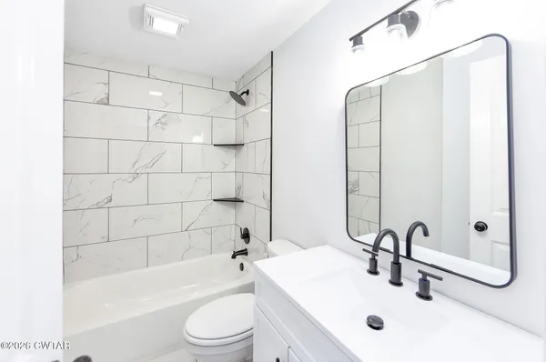 a kitchen with a sink cabinets and window