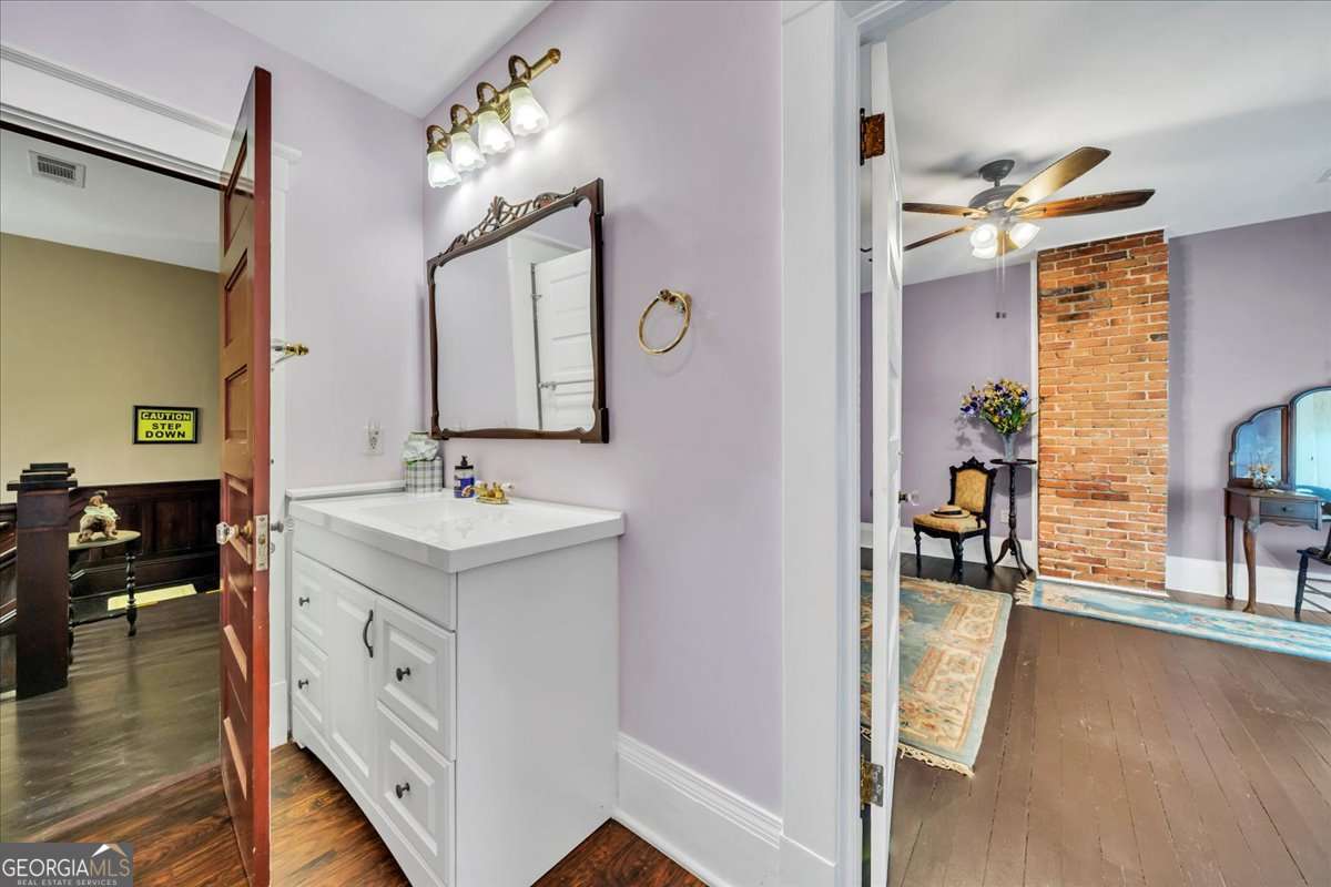 212 East Union Street Vienna, GA 31092 - Photo 31 of 62 a bathroom with a sink vanity and a mirror