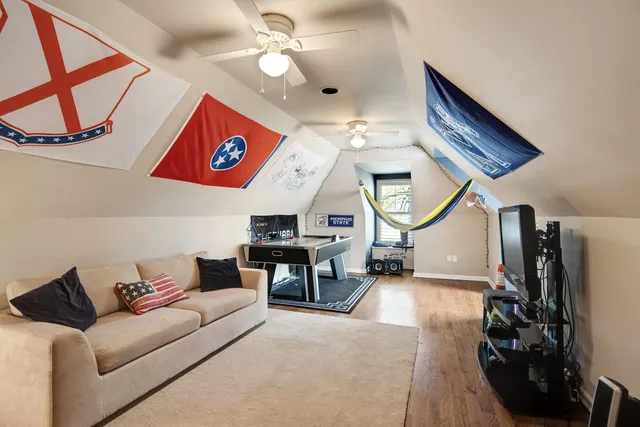 a living room with furniture a mirror and a flat screen tv