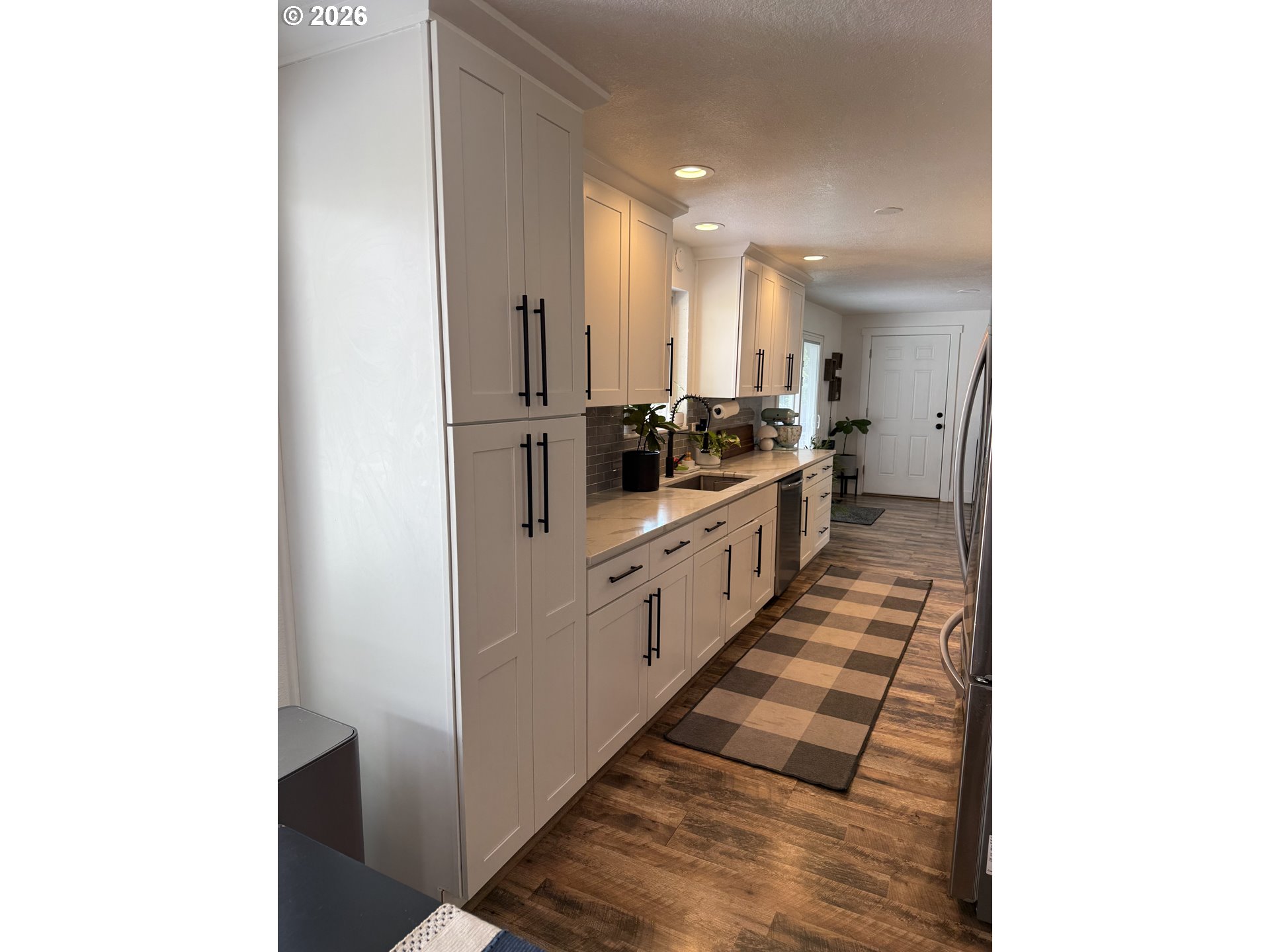 6974 Glacier Drive Springfield, OR 97478 - Photo 5 of 37 a large white kitchen with sink